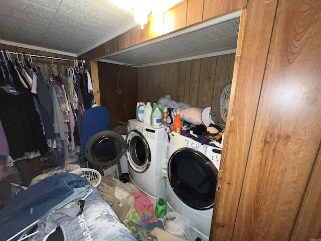 laundry area with washer and dryer and wood walls