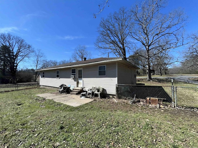 back of property featuring entry steps, a yard, fence, and a patio