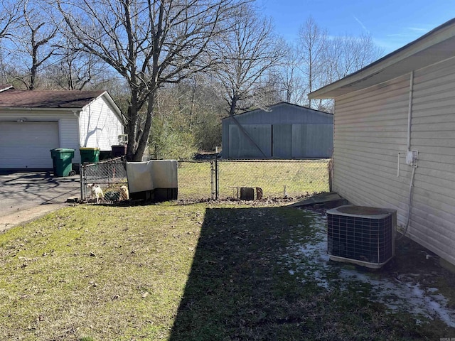 view of yard featuring an outbuilding, cooling unit, and fence