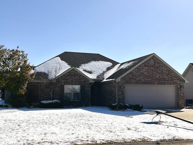 view of front of house featuring a garage, brick siding, and a shingled roof