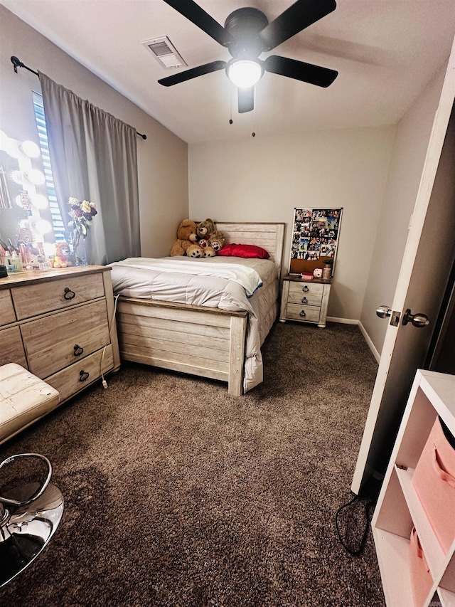 bedroom with visible vents, dark carpet, baseboards, and ceiling fan