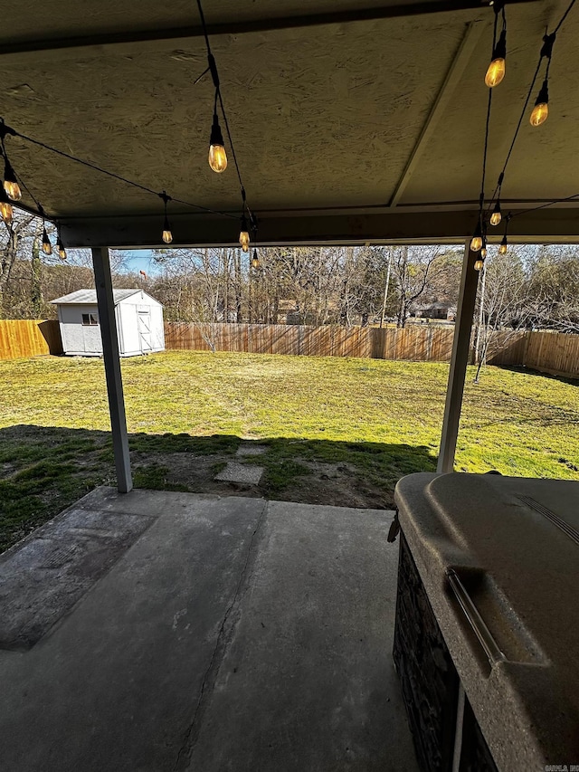 view of yard featuring an outbuilding, a shed, and a fenced backyard