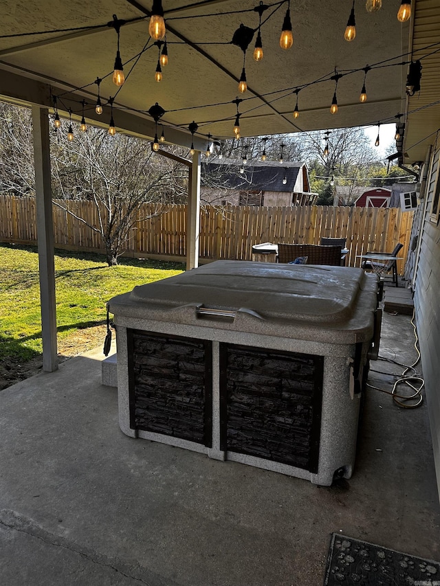 view of patio featuring a fenced backyard and a hot tub