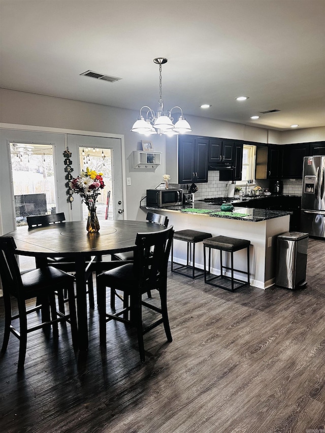 dining room with dark wood-type flooring, recessed lighting, and visible vents