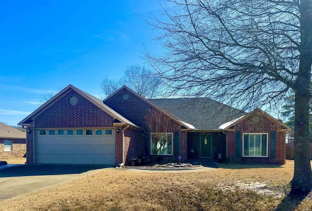 ranch-style home with a garage, brick siding, and driveway