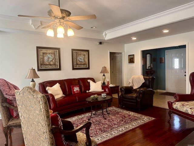 living room featuring ceiling fan, ornamental molding, wood finished floors, a tray ceiling, and recessed lighting