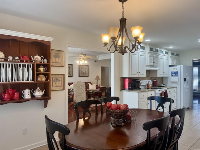 dining space with light tile patterned floors and ceiling fan with notable chandelier