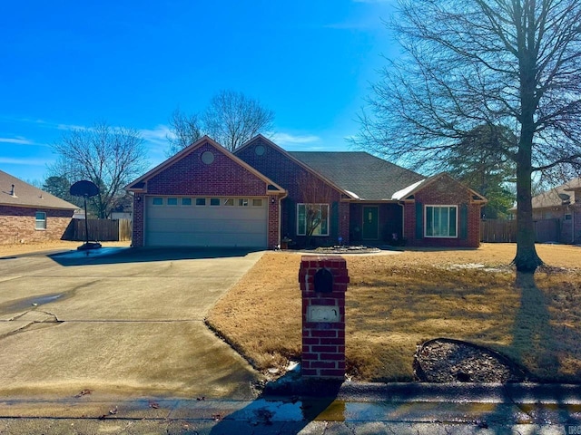 single story home featuring a garage, concrete driveway, brick siding, and fence