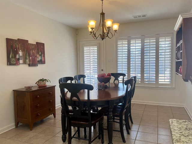 dining space featuring light tile patterned floors, a chandelier, visible vents, and baseboards