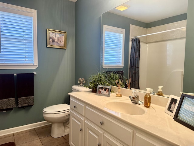 bathroom featuring curtained shower, toilet, vanity, tile patterned flooring, and baseboards