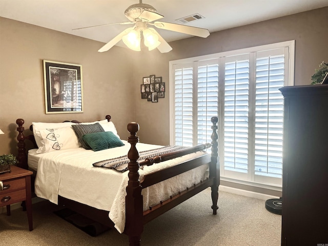 bedroom featuring a ceiling fan, light colored carpet, visible vents, and baseboards