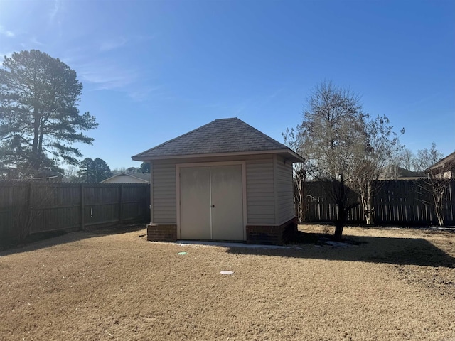 view of shed with a fenced backyard