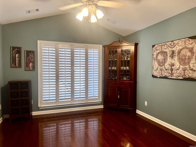 dining area featuring dark wood-style floors, lofted ceiling, visible vents, and baseboards