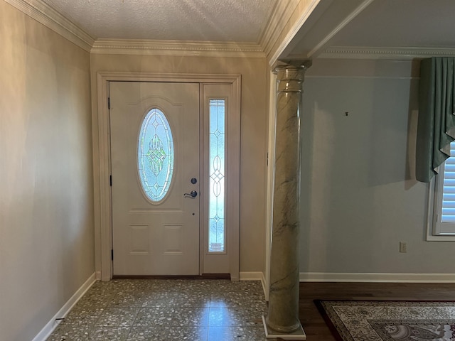 foyer entrance with crown molding, plenty of natural light, decorative columns, and baseboards