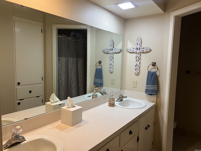 full bath featuring a sink, toilet, and double vanity