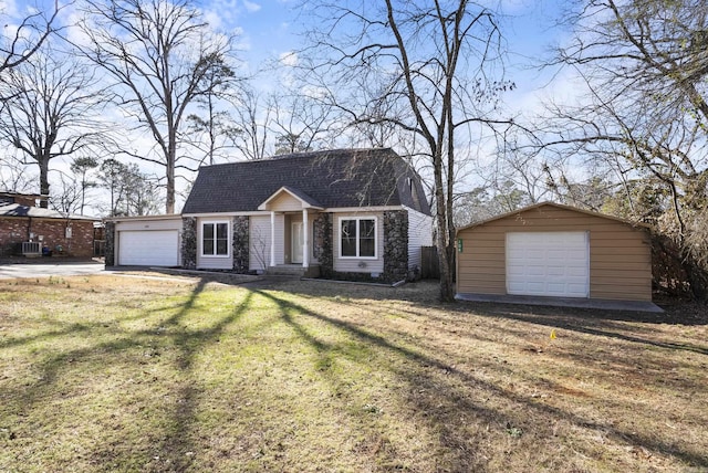 view of front of property with an outbuilding and a front yard