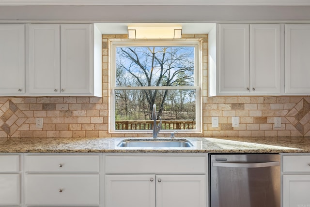 kitchen featuring a sink, light stone countertops, white cabinets, and dishwasher