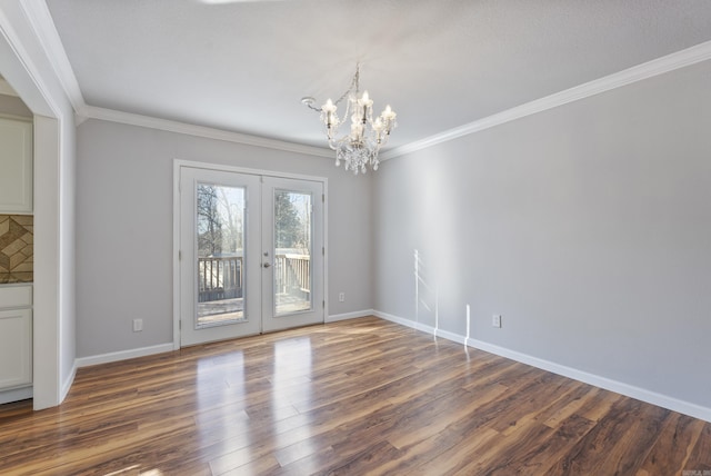 unfurnished dining area with dark wood-style flooring, baseboards, french doors, ornamental molding, and an inviting chandelier