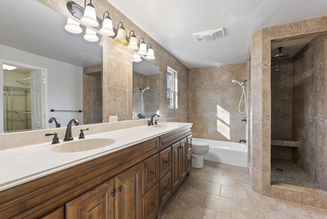 bathroom with visible vents, a sink, toilet, and tiled shower