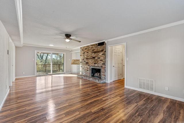 unfurnished living room featuring crown molding, a fireplace, visible vents, and dark wood-style flooring