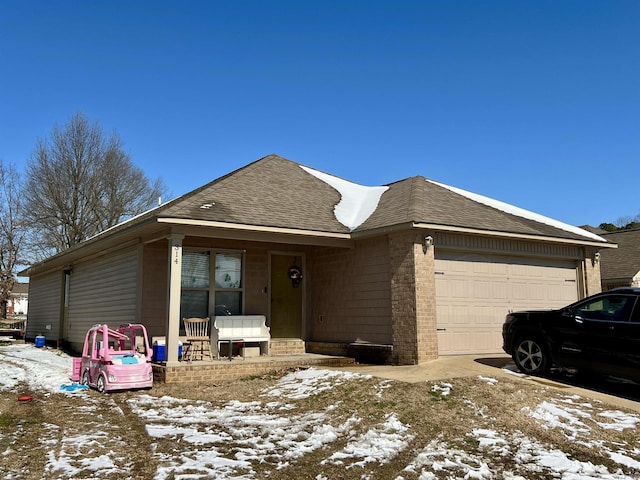 single story home with a shingled roof and an attached garage