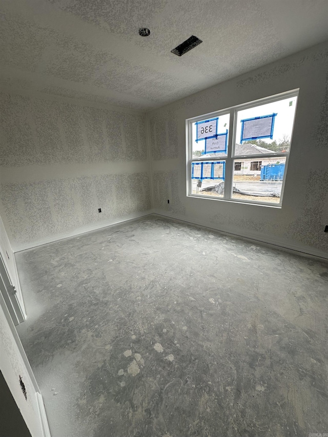 spare room featuring a textured ceiling