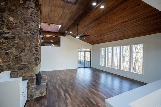 unfurnished living room with dark wood-style floors, a ceiling fan, wood ceiling, vaulted ceiling with skylight, and baseboards