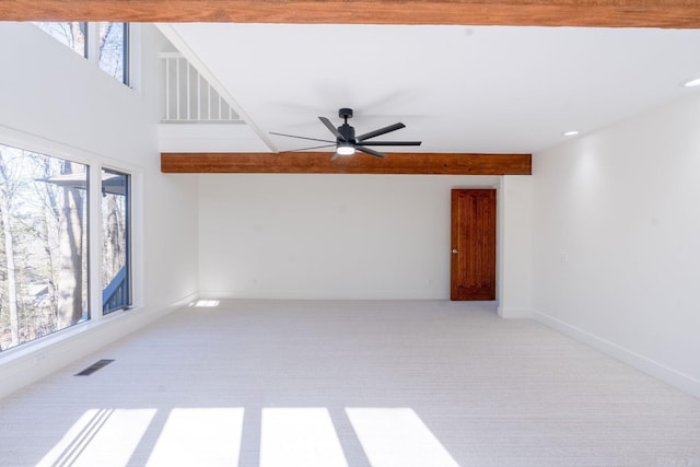 unfurnished room featuring ceiling fan, visible vents, baseboards, and light colored carpet