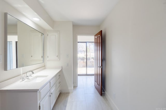 bathroom featuring tile patterned floors, vanity, and baseboards