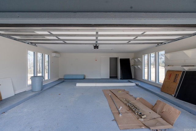 garage featuring a wall mounted air conditioner and a garage door opener