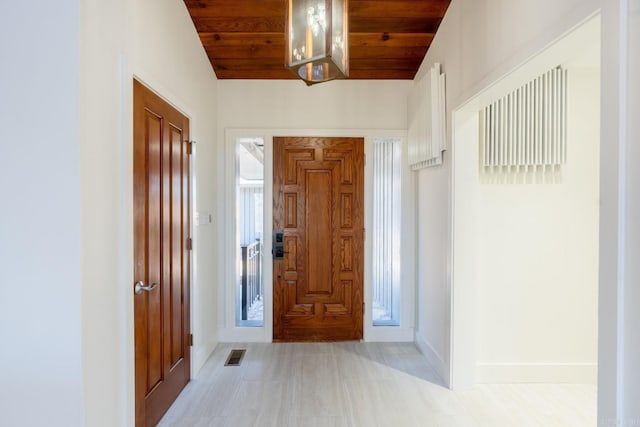 entrance foyer featuring visible vents, vaulted ceiling, wood ceiling, and baseboards