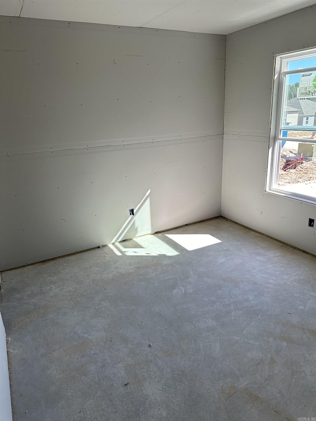 unfurnished room with concrete floors