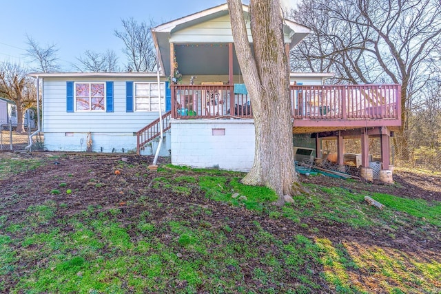 rear view of property featuring a deck