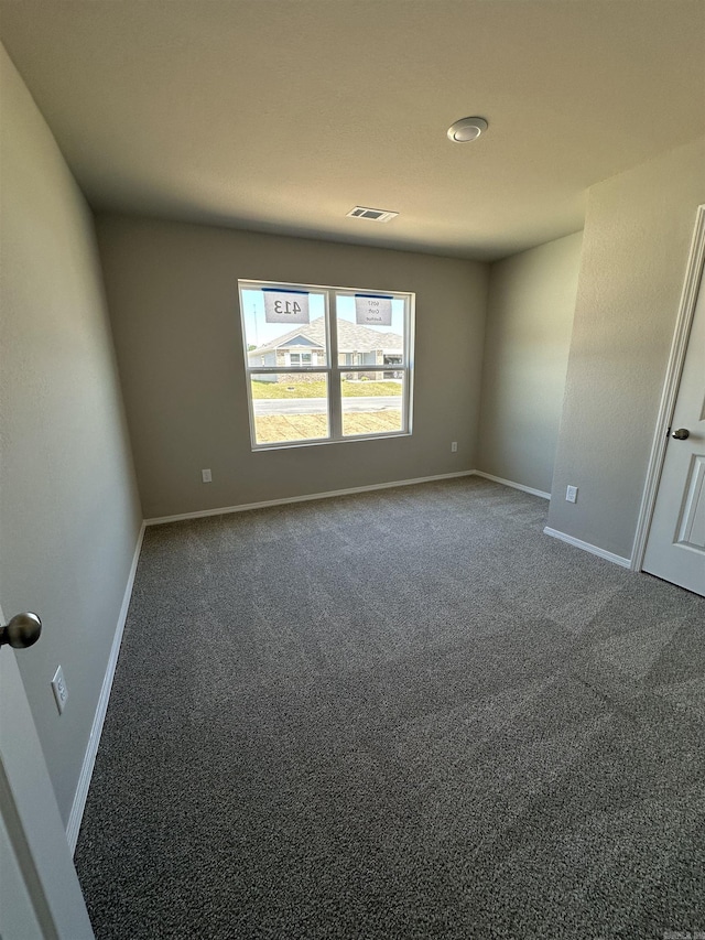 carpeted empty room with baseboards and visible vents
