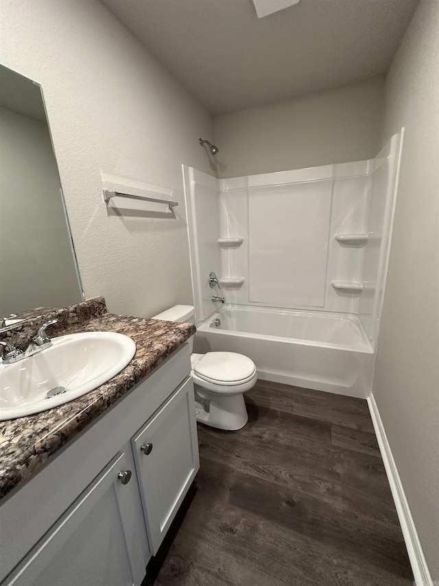 full bathroom featuring vanity, washtub / shower combination, toilet, and wood finished floors