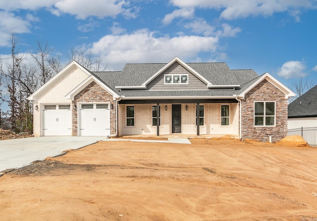 craftsman house featuring a garage, stone siding, roof with shingles, and driveway