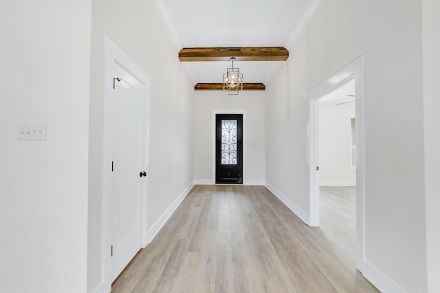 entryway with light wood-type flooring, an inviting chandelier, baseboards, and beamed ceiling