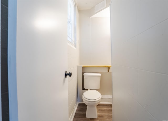 bathroom with visible vents, toilet, and wood finished floors