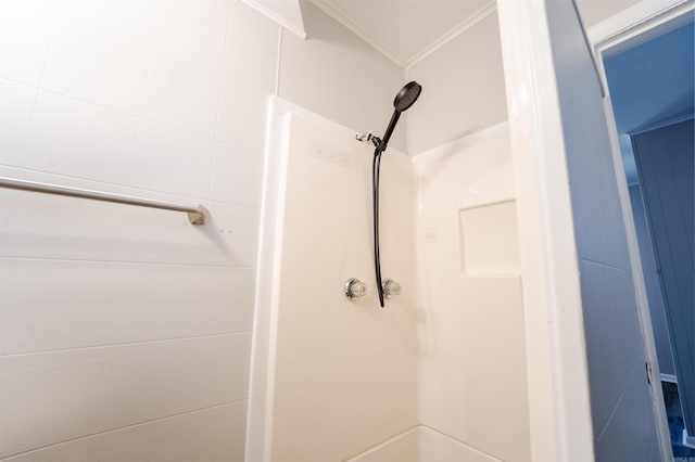 full bath with ornamental molding and a shower