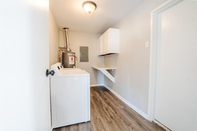 laundry area featuring cabinet space, electric panel, baseboards, washing machine and clothes dryer, and water heater