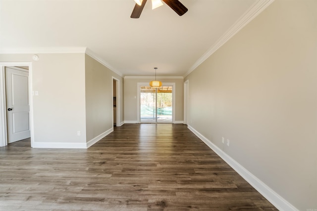 empty room featuring crown molding, baseboards, ceiling fan, and wood finished floors