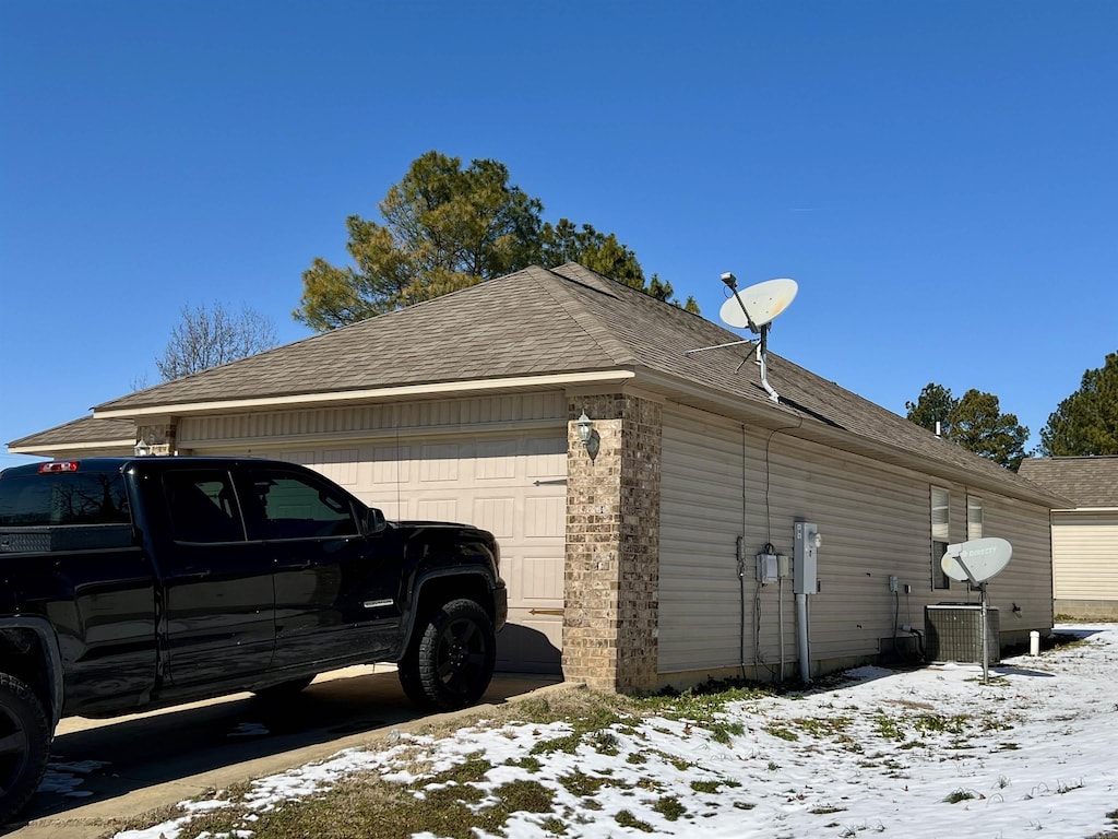 snow covered property featuring a garage