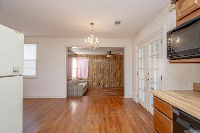 interior space with a healthy amount of sunlight, visible vents, dark wood finished floors, and french doors