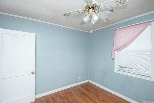 unfurnished room with a ceiling fan, dark wood-style flooring, crown molding, and baseboards