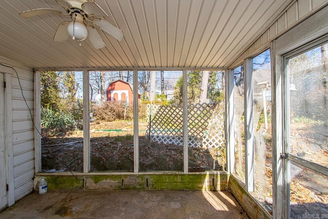 unfurnished sunroom featuring wooden ceiling and a ceiling fan