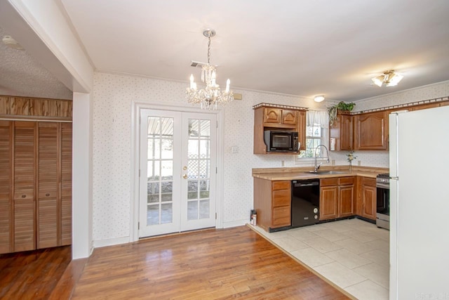 kitchen featuring black appliances and wallpapered walls