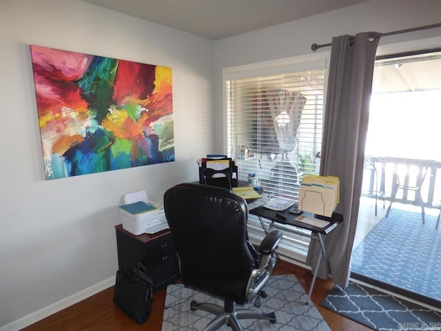 office area featuring baseboards and wood finished floors