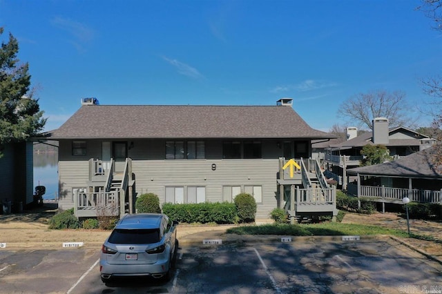 townhome / multi-family property with uncovered parking and stairway