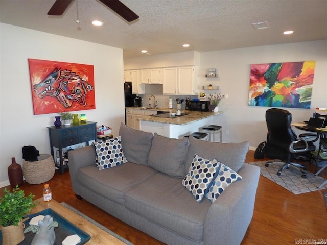 living area featuring visible vents, recessed lighting, a ceiling fan, and light wood-style floors