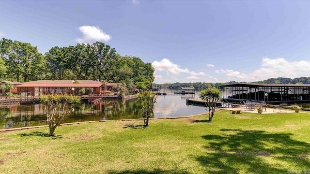 view of dock featuring a water view and a yard